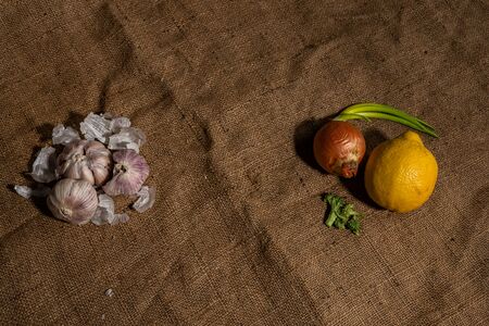 Fresh garlic and other natural cold remedies on sackcloth backgroundの写真素材