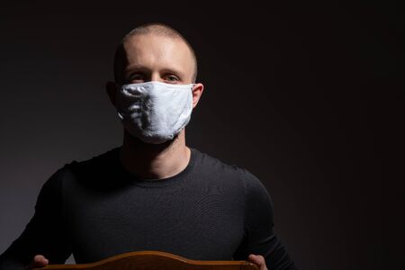 Portrait of a young man in protective medical mask against viruses and infections. Coronavirus 2019-ncov covid-19 conceptの写真素材