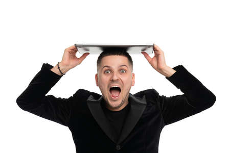 Excited businessman posing isolated over white wall background holding laptop computerの写真素材