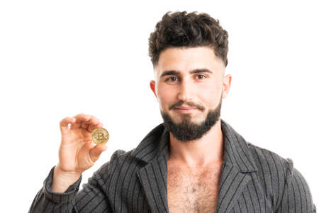 Young bearded stylish businessman holding bitcoin isolated on whiteの写真素材