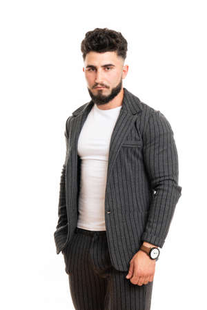 Masculine glamorous groomed attractive elegant serious financier looking at camera isolated on white backgroundの写真素材