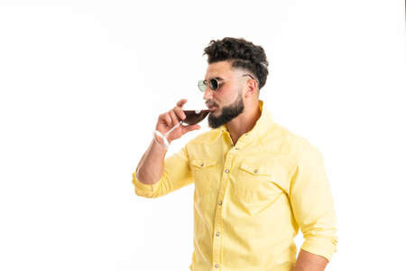 Sommelier, degustator with glass of red wine, winery, male winemaker. Beard man, bearded, sommelier tasting red wine. Man with a glass of wine in his handsの写真素材
