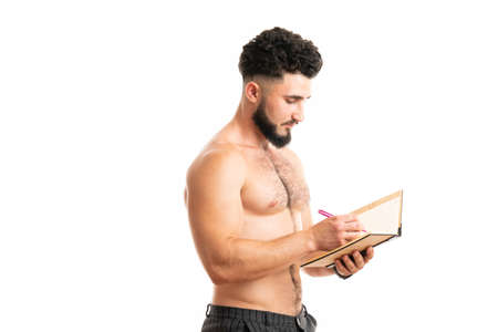 Writing master. University student do writing task isolated on white. Handsome man write in copybookの写真素材