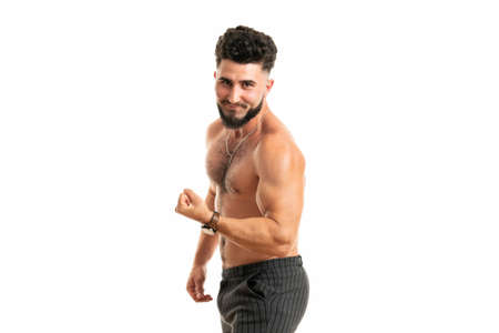Sport, gym and strength concept. Sexy good-looking muscular young man in perfect shape, standing with naked torso, raising hand proudly showing strong big musclesの写真素材