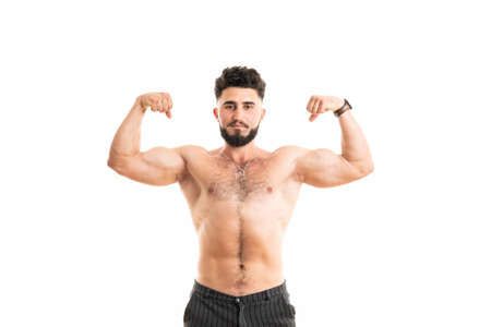 Muscular man bodybuilder isolated on a white background. Male shows his musclesの写真素材