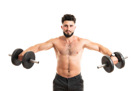 Torso shot of a young man with bare chest lifting dumbbells. Fit young man exercising with dumbbells on white backgroundの写真素材