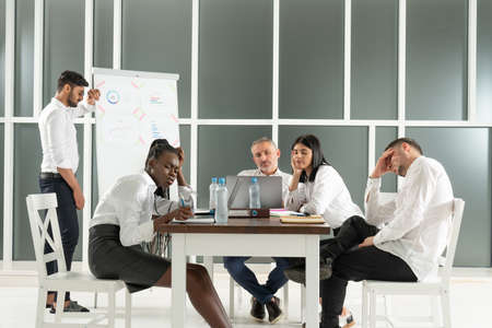 Business, teamwork, people and crisis concept - business team sitting sad and solving problem in officeの写真素材
