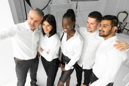 Group of multiethnic business workers smiling happy and confident. Posing together with smile on face looking at the camera at the office, making selfieの写真素材