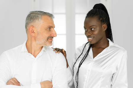 African woman molesting her male colleague in office, closeup. Sexual harassment at work