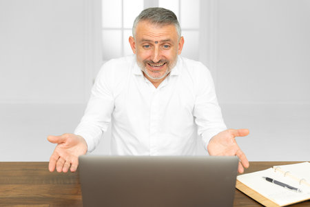 Confused young man frustrated by online problem looking at laptop screen, worker troubled doing hard job on computer making notes, student feels stressed about difficult learning failing test or examの写真素材