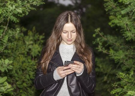 a girl brunette holds a phone