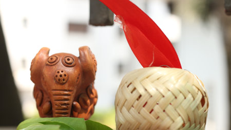 Ceramic souvenir in the form of an elephant with a red ribbonの写真素材