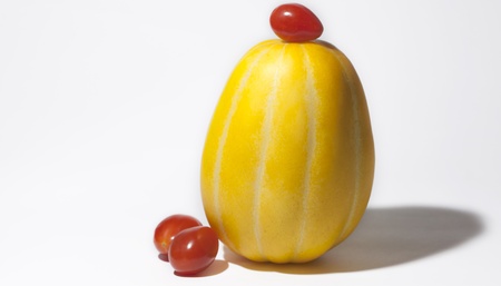 Korean Melon and cherry tomatoes on white backgroundの写真素材