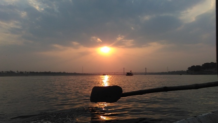 sunset with oak of a boatの写真素材
