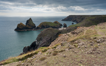 Kynance Cove on the coast of Cornwall, under broken cloud.