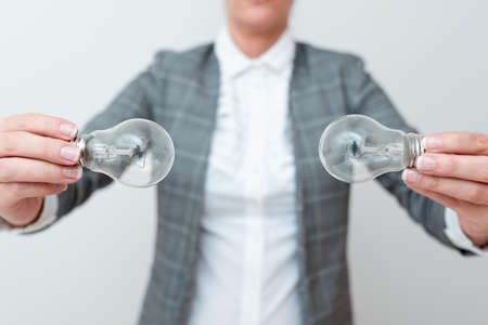 Lady Holding Two Lamps Upside Down With Outfit Proposing New Ideas For Project, Business Woman Carry...