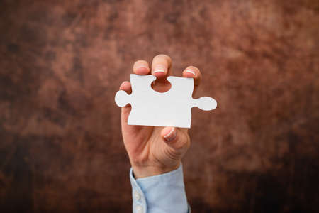 Hands Holding Two Pieces Of Jigsaw Puzzle.Cooperation For Finding And Resolving Missing Ideas At Work.Businessman Find Strategy For Resolving, Connecting Thoughtsの写真素材