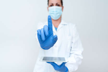 Demonstrating Medical Technology Presenting New Scientific Discovery Laboratory Presentations Science Discussions Wearing Occupation Workwear Protective Gearsの写真素材