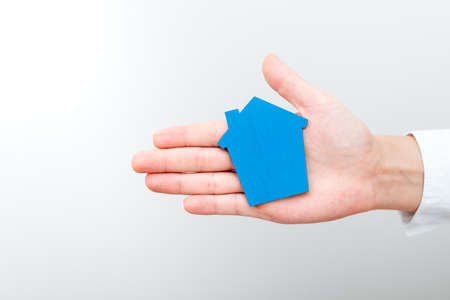 A Lady Holding Home In Business Outfit Presenting Possibility Of Owning Your Own Real Estate. Buying...