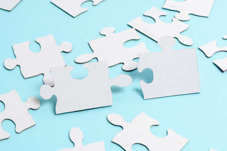 Close-Up White Jigsaw Pattern Puzzle Pieces To Be Connected With Missing Last Piece Positioned On A...
