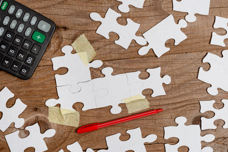 Close-Up White Jigsaw Pattern Puzzle Pieces To Be Connected With Missing Last Piece Positioned On A...