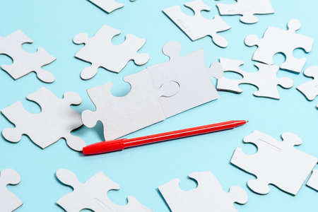 Close-Up White Jigsaw Pattern Puzzle Pieces To Be Connected With Missing Last Piece Positioned On A...