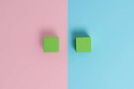 Comparison of Two Objects Blocks Pencils Sticker Notes Facing Inward Outward Making An Arrangement Reflection On a Separated Coloured Background Shot In A Flat Lay Perspectiveの写真素材