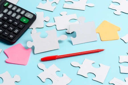 Close-Up White Jigsaw Pattern Puzzle Pieces To Be Connected With Missing Last Piece Positioned On A Flat Lay Background With Different Texture And Paper Supplies Accesoriesの写真素材