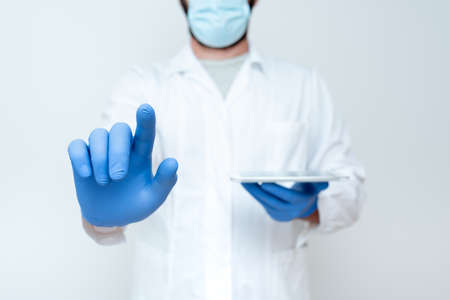 Demonstrating Medical Technology, Presenting New Scientific Discovery, Laboratory Presentations, Science Discussions, Wearing Occupation Workwear Protective Gearsの写真素材