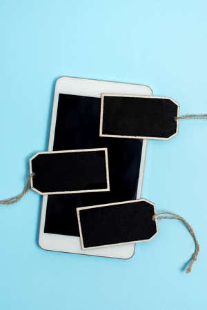 Collection of Real Blank Empty Sticker Card Tag With An Elastic Band On A Different Color Background Containing Modern Gadget Checklist For Labeling Informative Content Purposesの写真素材