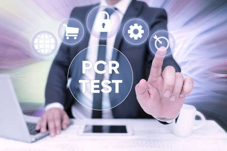 Conceptual caption Pcr Test. Word for qualitative detection of viral genome within the short seqeunce of DNA Bussiness Man Sitting Desk Laptop And Phone Pointing Futuristic Technology.の写真素材