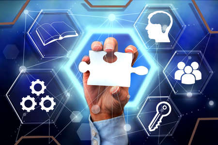 Hand Holding Jigsaw Puzzle Piece Unlocking New Futuristic Technologies. Palm Carrying Puzzles Part...
