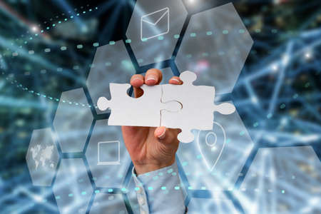 Hand Holding Jigsaw Puzzle Piece Unlocking New Futuristic Technologies. Palm Carrying Puzzles Part...