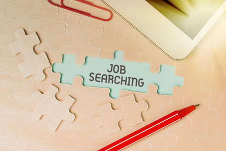 Writing displaying text Job Searching. Business idea listing the possible occupation that you are capable of Building An Unfinished White Jigsaw Pattern Puzzle With Missing Last Pieceの写真素材