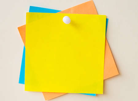 Colorful Paper Notes Stacked Together And Pinned On The Wall. Different Colored Sheets Of Note Attached On A Plain Wallpaper With A Pin.の写真素材