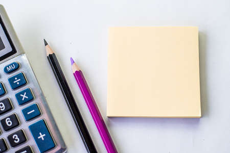 Plain Spiral Notebook With Pen Beside Calculator And Coins On Table. Simple Notepad And Ballpen...