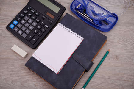 Blank Notebook Page With A Calculator And Geometric Stationery Sets On Top Of A Table. Empty Lined Notepad With Calculation Compass Office Supplies Over Desk.の写真素材