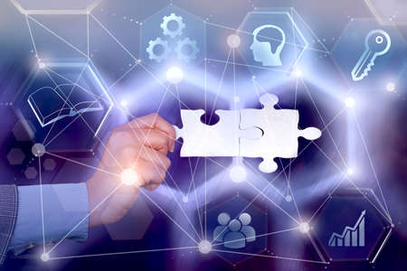 Hand Holding Jigsaw Puzzle Piece Unlocking New Futuristic Technologies. Palm Carrying Puzzles Part...
