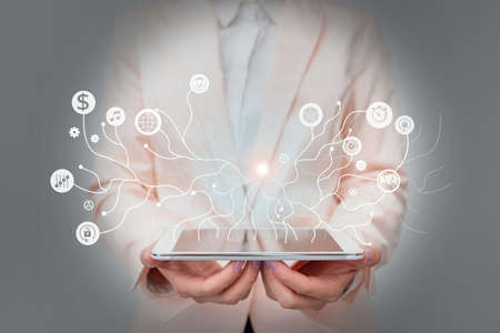Lady In Uniform Standing Holding Tablet And A Pen Displaying Holographic Tech. Woman In Suit...
