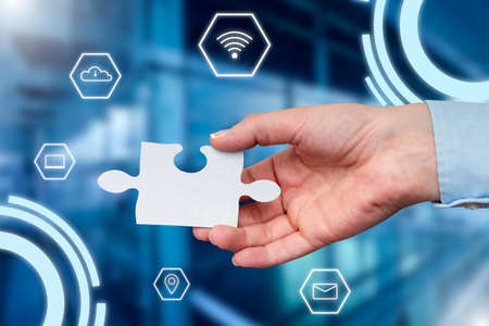 Hand Holding Jigsaw Puzzle Piece Unlocking New Futuristic Technologies. Palm Carrying Puzzles Part Displaying Solving Late Innovative Virtual Ideas.の写真素材
