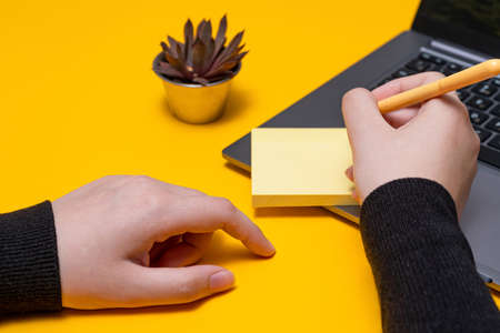 Woman Hand Holding Blank Notes Writing New Messege Updates Ideas Next To Laptop. Lady Palm Showing Envelope Folding Sending Letters Post Address And Email Computer.の写真素材