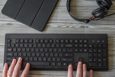 Hands Pointing Pressing Computer Keyboard Keys Typewriting New Ideas With Headphones Tablet. Fingers Tapping Typing Fresh Thoughts Using Wireless Notebook Keypad.の写真素材