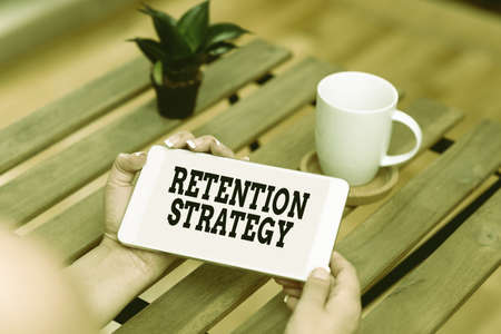 Handwriting text Retention Strategy. Word Written on activities to reduce employee turnover and...