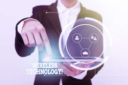 Text showing inspiration Wireless Technology. Word for a technology that allows wireless communication Lady In Suit Pointing On Tablet Showing Futuristic Graphic Interface.の写真素材