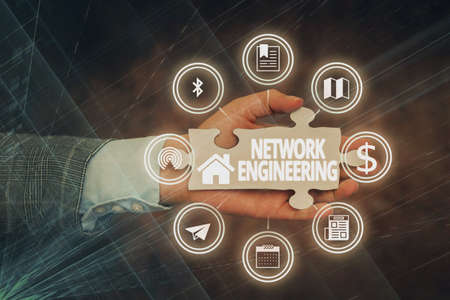 Text sign showing Network Engineering. Internet Concept field concerned with internetworking service requirement Hand Holding Jigsaw Puzzle Piece Unlocking New Futuristic Technologies.の写真素材