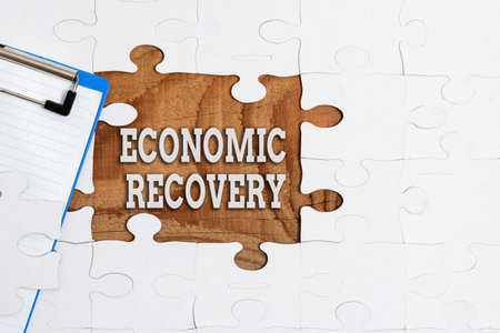 Text showing inspiration Economic Recovery. Business approach rise of business activity signaling the end of a recession Building An Unfinished White Jigsaw Pattern Puzzle With Missing Last Pieceの写真素材