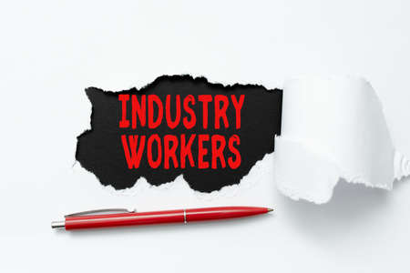 Sign displaying Industry Workers. Business idea one that works especially at manual or industrial labor Tear on sheet reveals background with pen on boardの写真素材