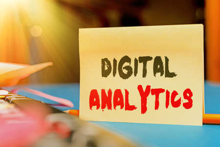 Conceptual caption Digital Analytics. Conceptual photo the analysis of qualitative and quantitative data Multiple Assorted Collection Office Stationery Photo Placed Over Tableの写真素材
