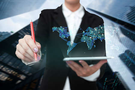 Lady In Uniform Standing Holding Tablet And Virtually Typing With Pen. Business Woman Carrying Pad Typing And Displaying New Futuristic Technologies.の写真素材