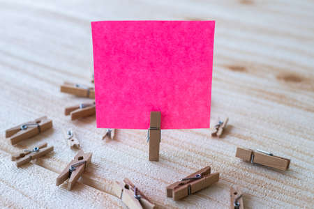 Piece Of Blank Square Note Surrounded By Laundry Clips Showing New Meaning. Empty Sticky Paper...